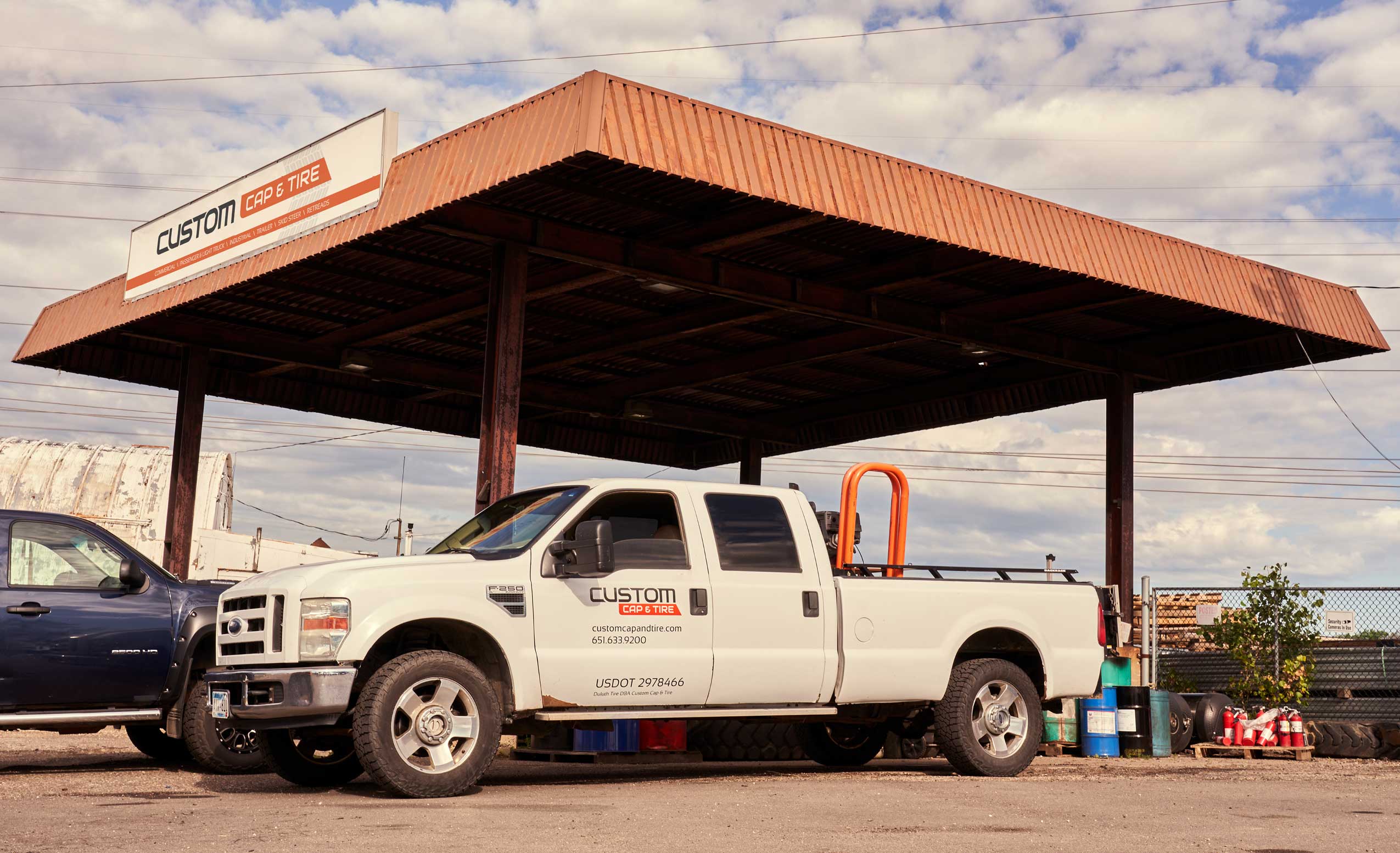 Custom Cap & Tire's awning sign, above a truck with their custom decals.