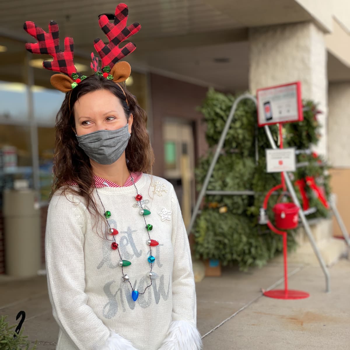 Melissa McGath by a Salvation Army collection bucket.