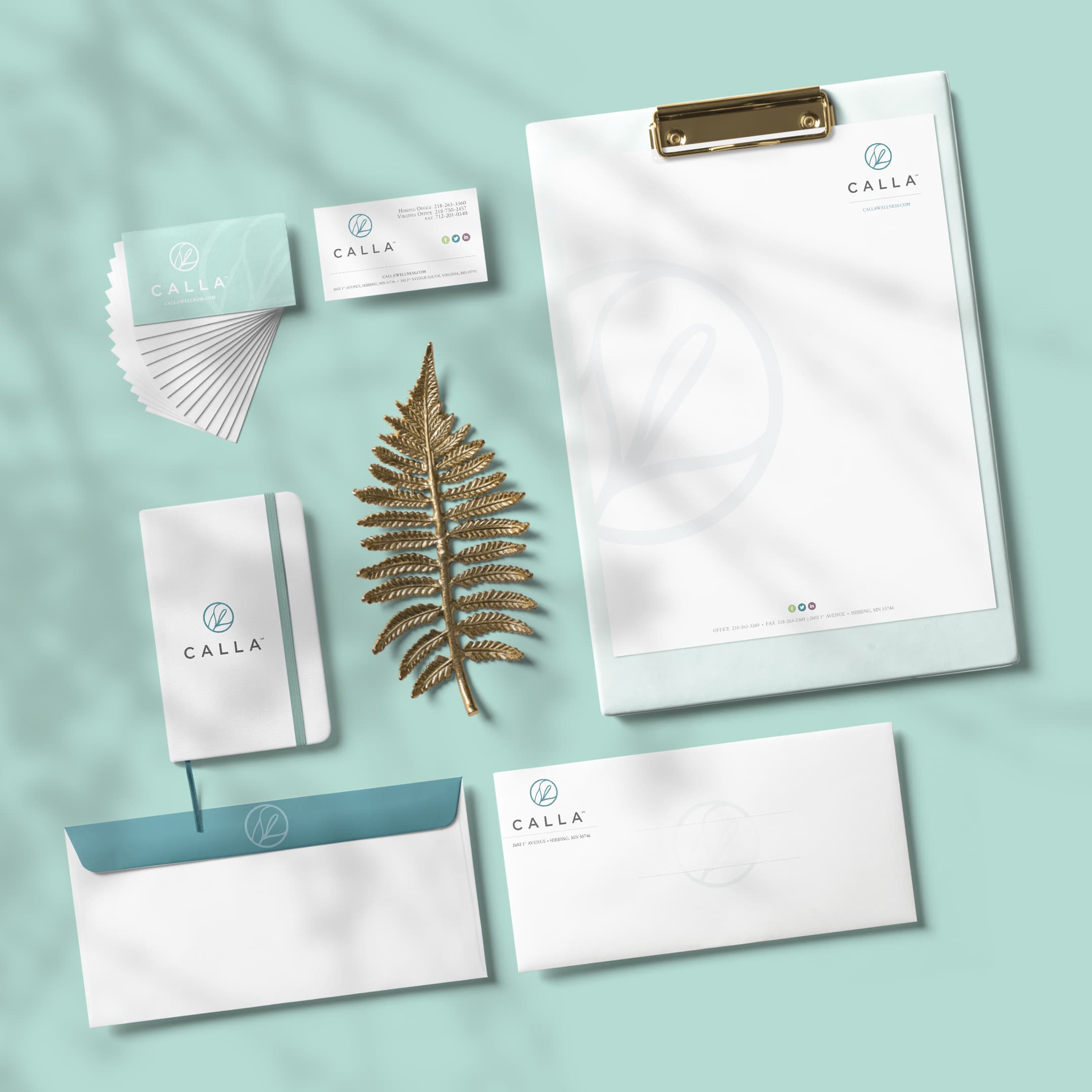 Calla business system, including business cards, letterhead, envelopes and a notebook.